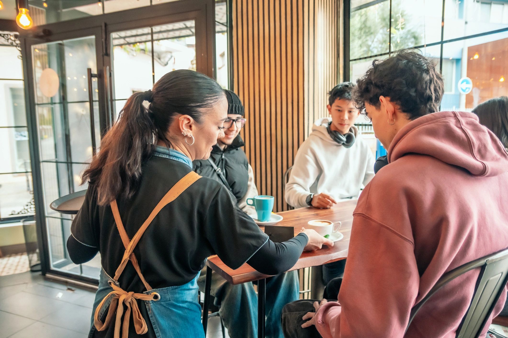 Barista serving coffee to customers